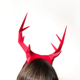 Kid wearing deer antlers headband